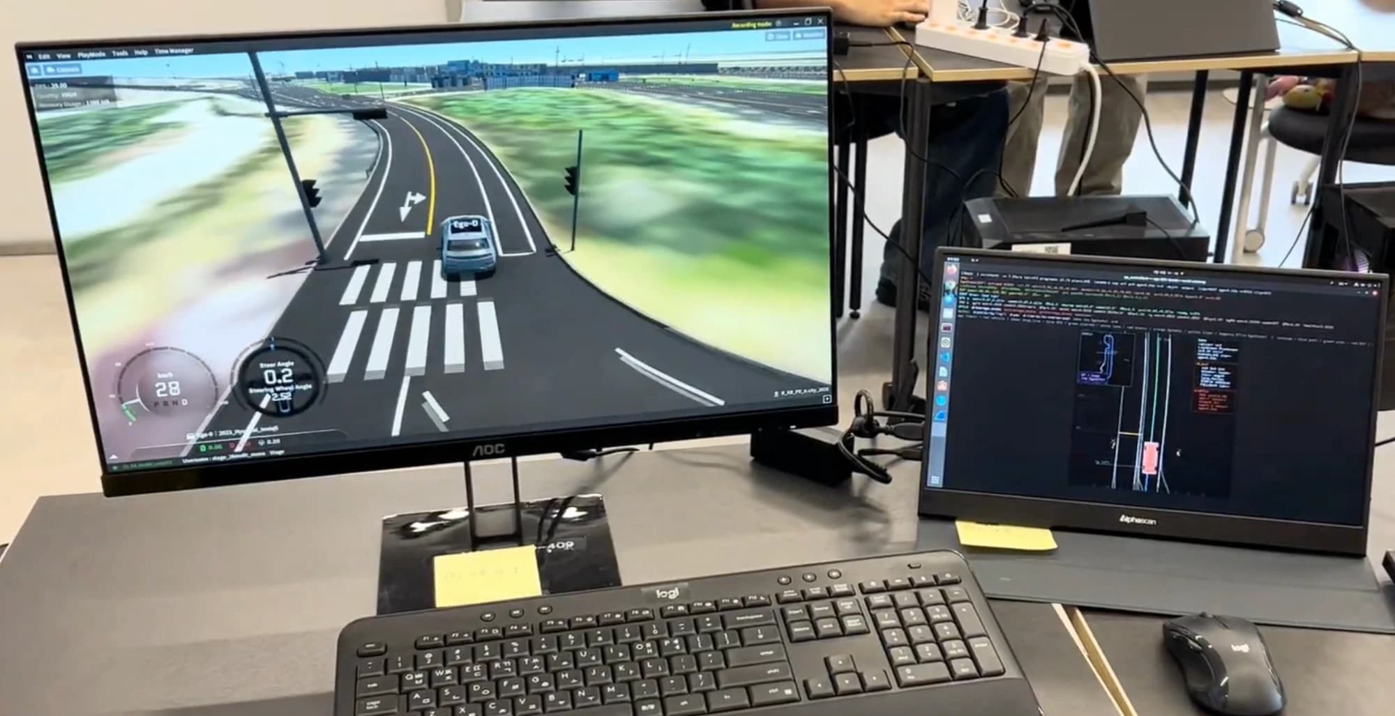 MORAI simulator on one monitor and the driving stack's terminal and visualization on a laptop